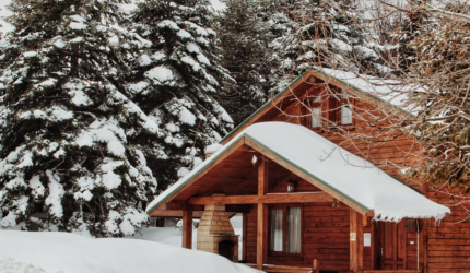 Cabin in the woods covered in snow